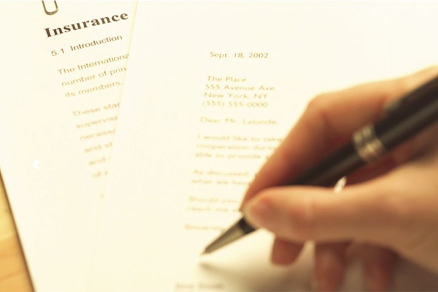 Person signing insurance paperwork