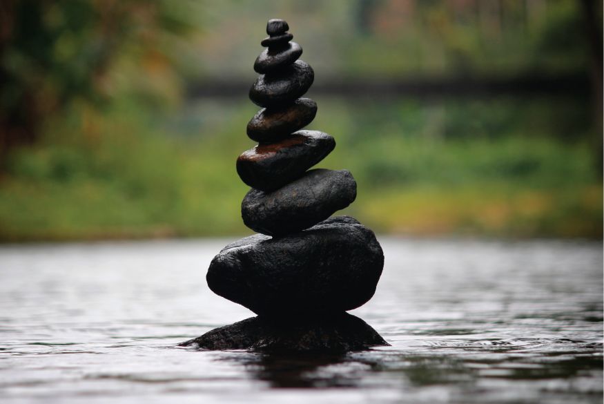 Rocks piled on top of each other in a stream