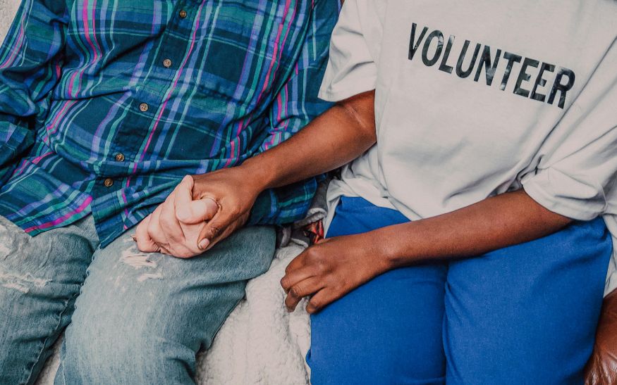 Volunteer assisting another person